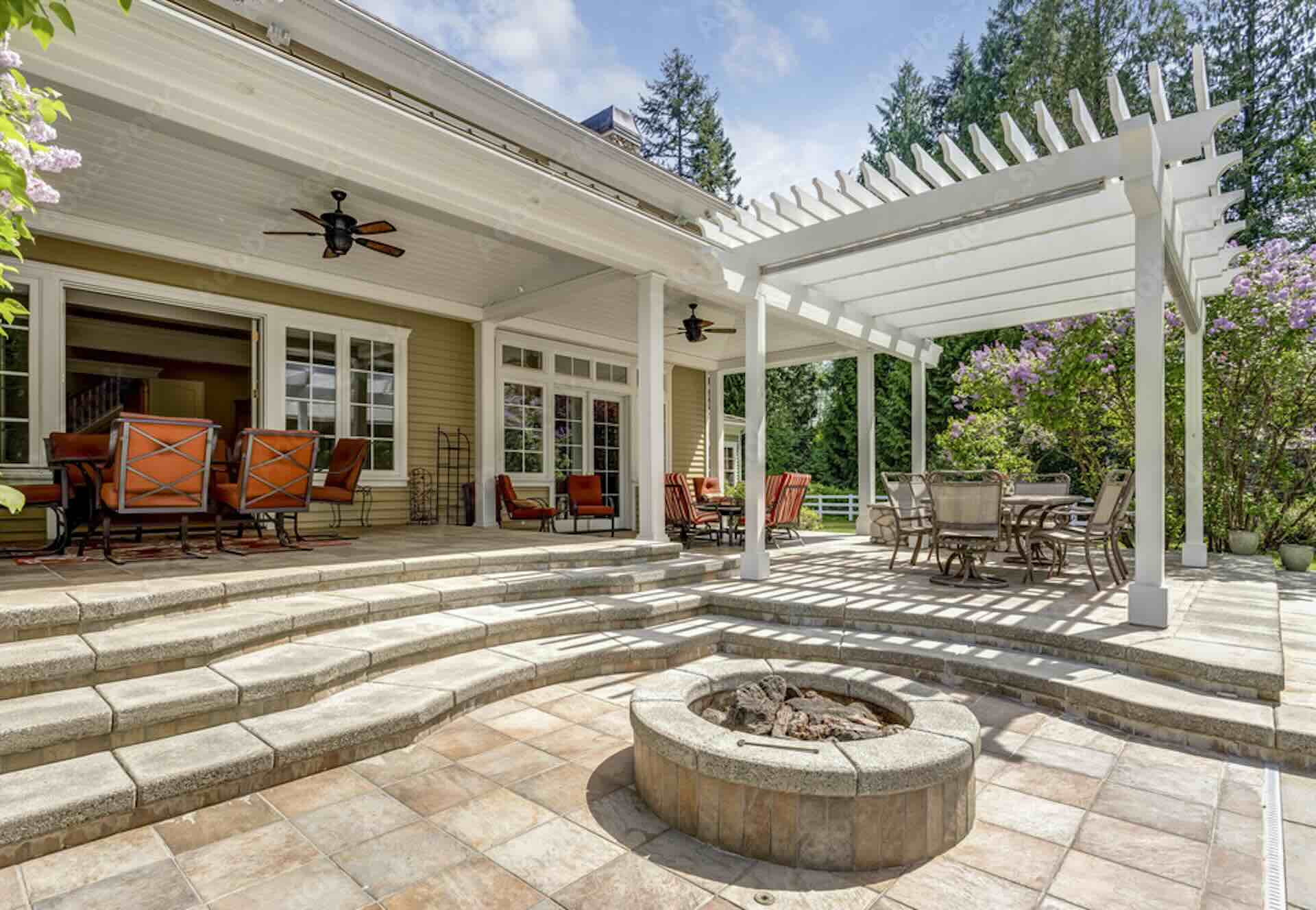 Spacious patio with pergola and outdoor seating.