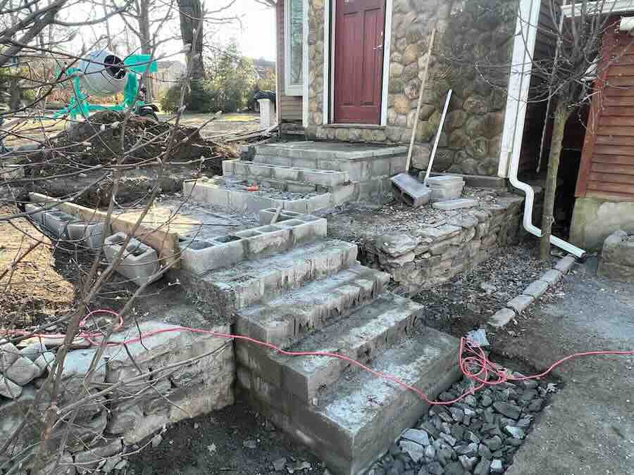 Stone stairs under construction at house entrance