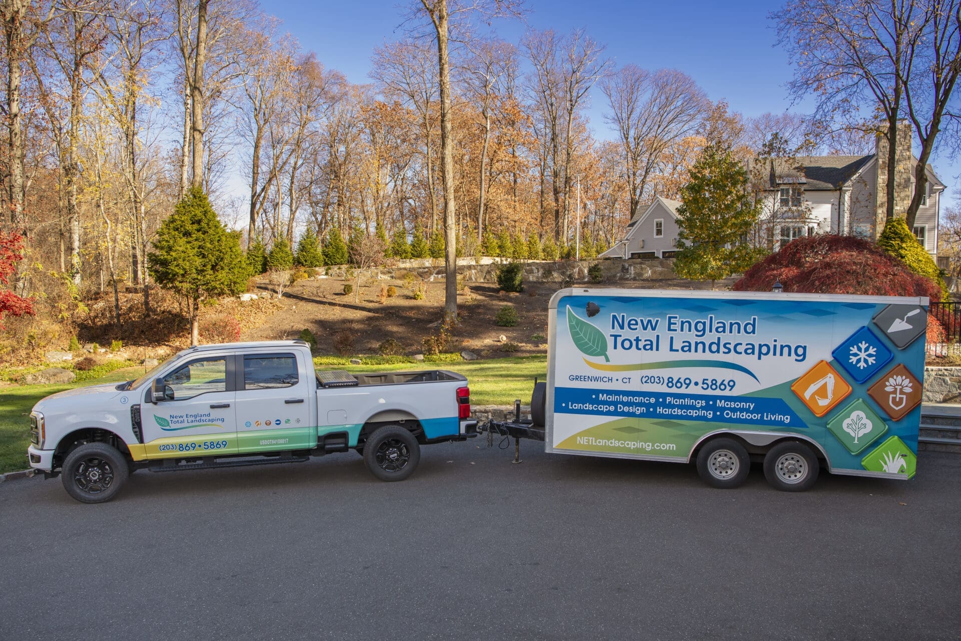 New England landscaping truck with trailer in autumn scenery