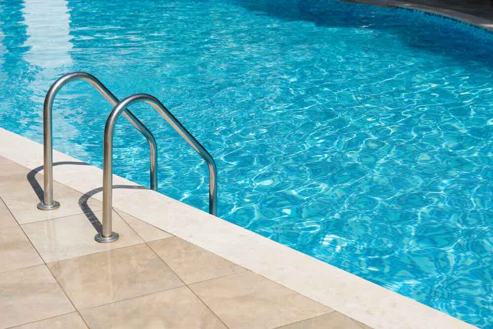 Outdoor swimming pool with metal ladder